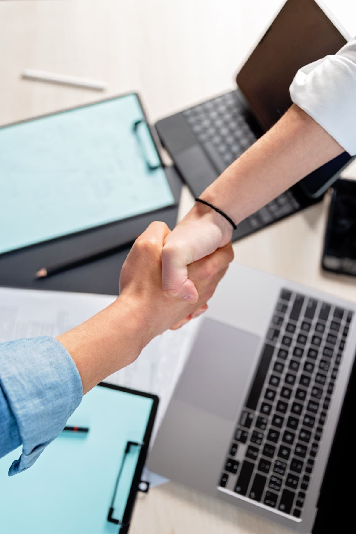 Professional partners meeting across a desk